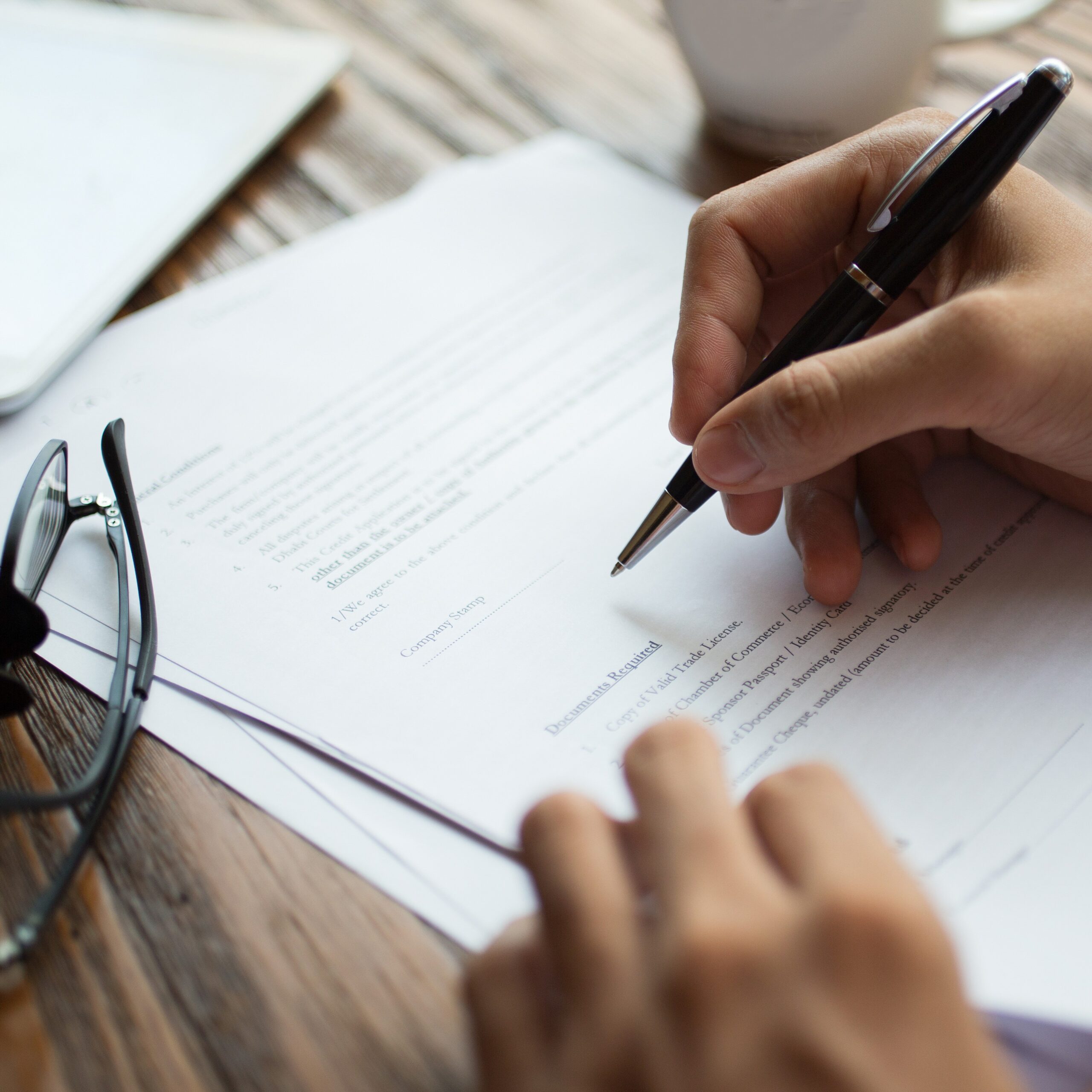 Businessman examining papers at table