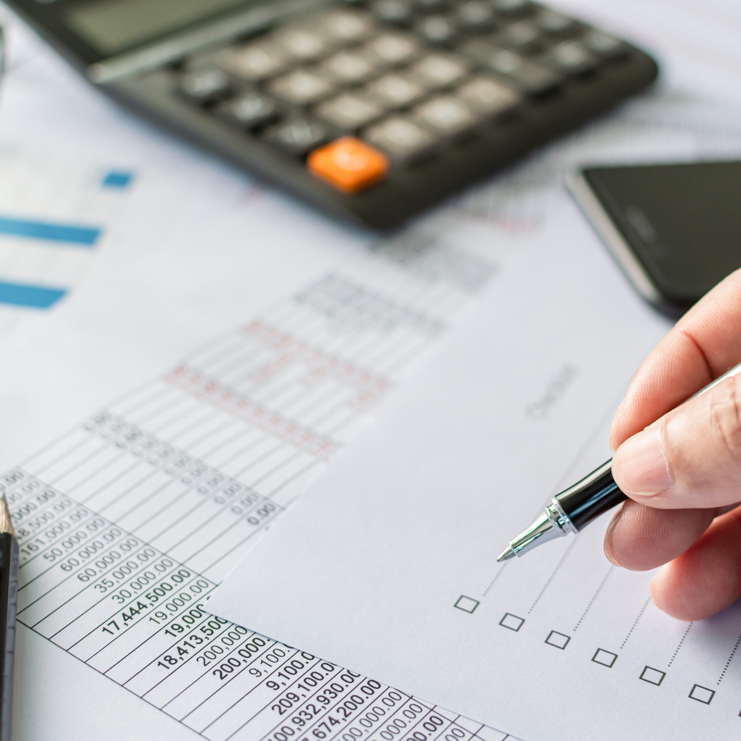 professional businessperson man hand holding pen and checking list report information data document or paperwork business of banking finance accounting on desk office for management investment stock