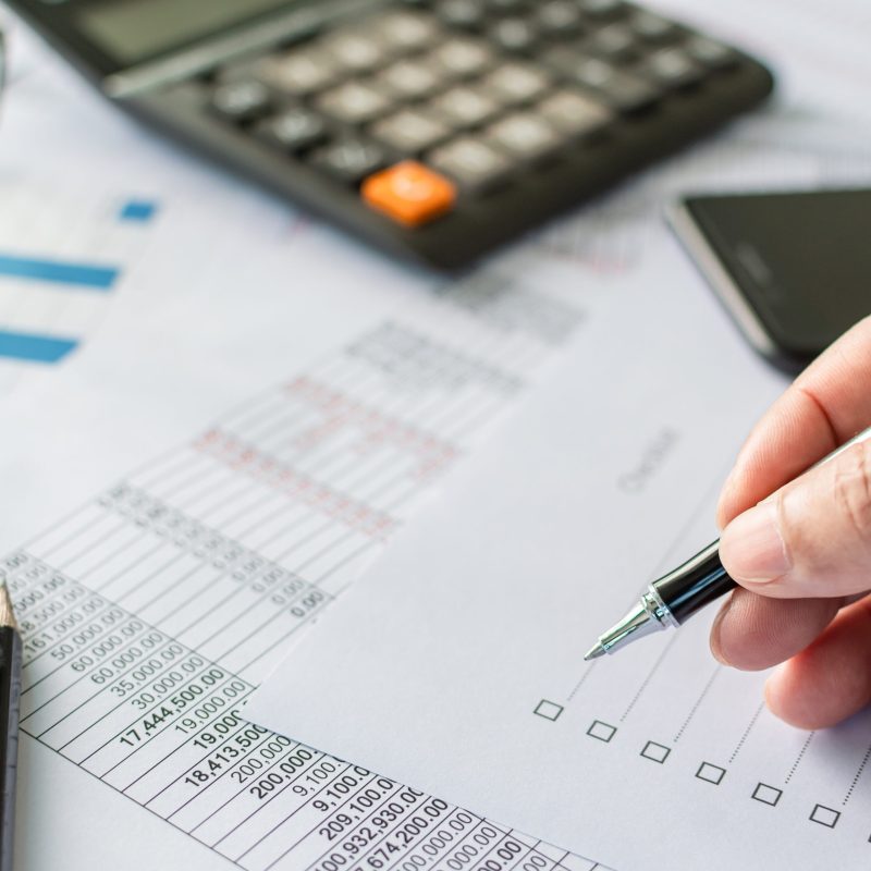 professional businessperson man hand holding pen and checking list report information data document or paperwork business of banking finance accounting on desk office for management investment stock
